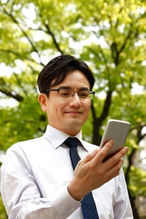 an asian man in glasses posing outdoors