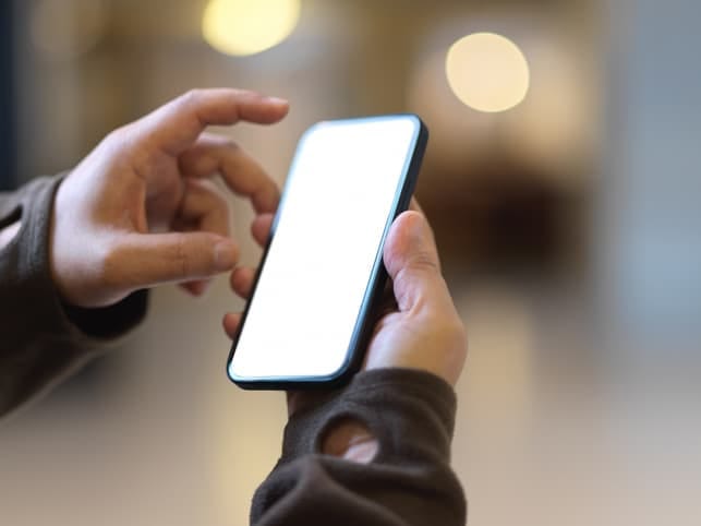 hands of a man checking his phone
