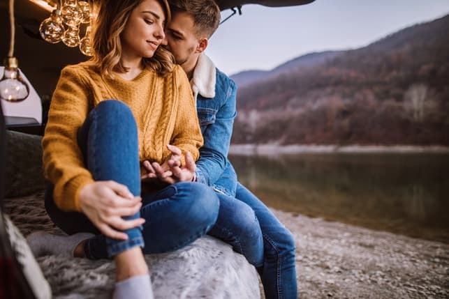 sweet couple chilling by the lake