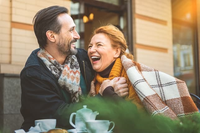 a mature couple is laughing and having fun together on a date