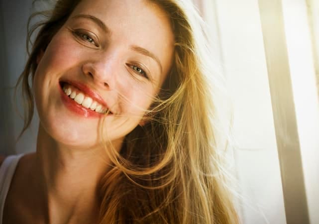a portrait of a young blonde woman smiling