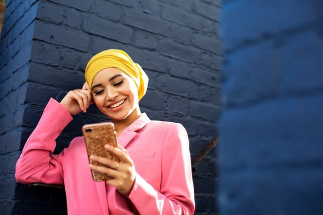 a portrait of a young Muslim woman smiling
