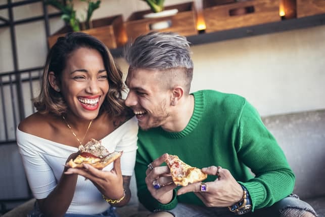 an interracial couple laughing and having fun together