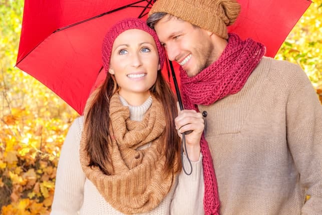 a couple walking under one umbrella
