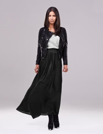 a beautiful asian woman posing in a long black skirt