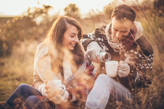 a couple having picnic outdoors together