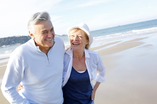 a senior couple is having a date on a beach