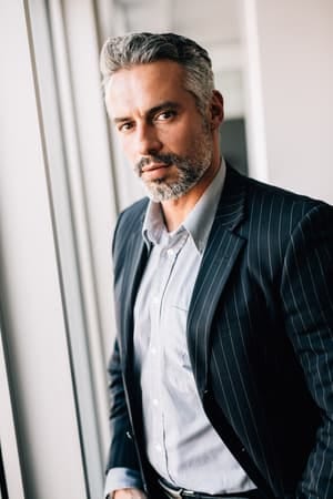 a serious man over 40 posing indoors