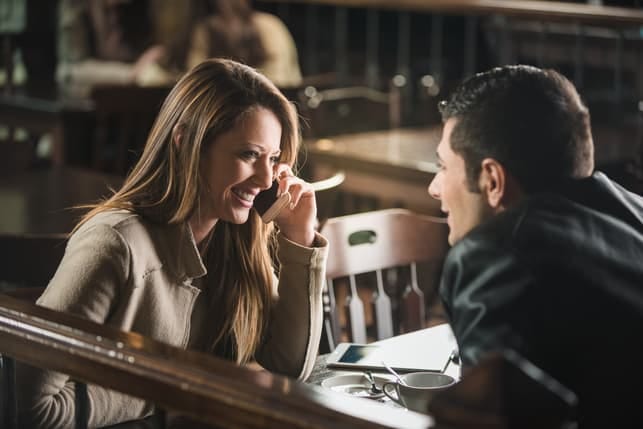 a couple chatting and laughing on a date at a restaurant